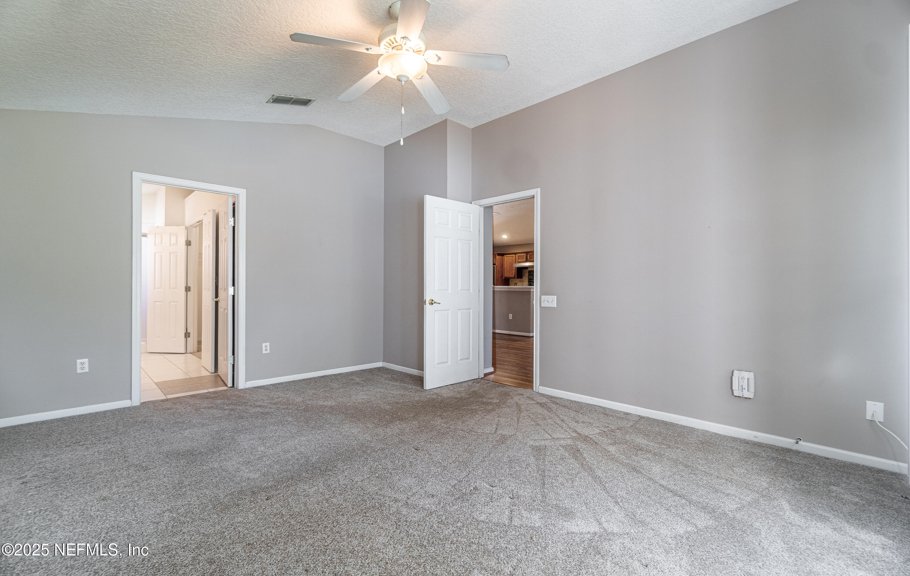 1325 Fairway Village Drive Fleming Island, FL 32003 - Photo 13 of 36 an empty room with closet and a ceiling fan