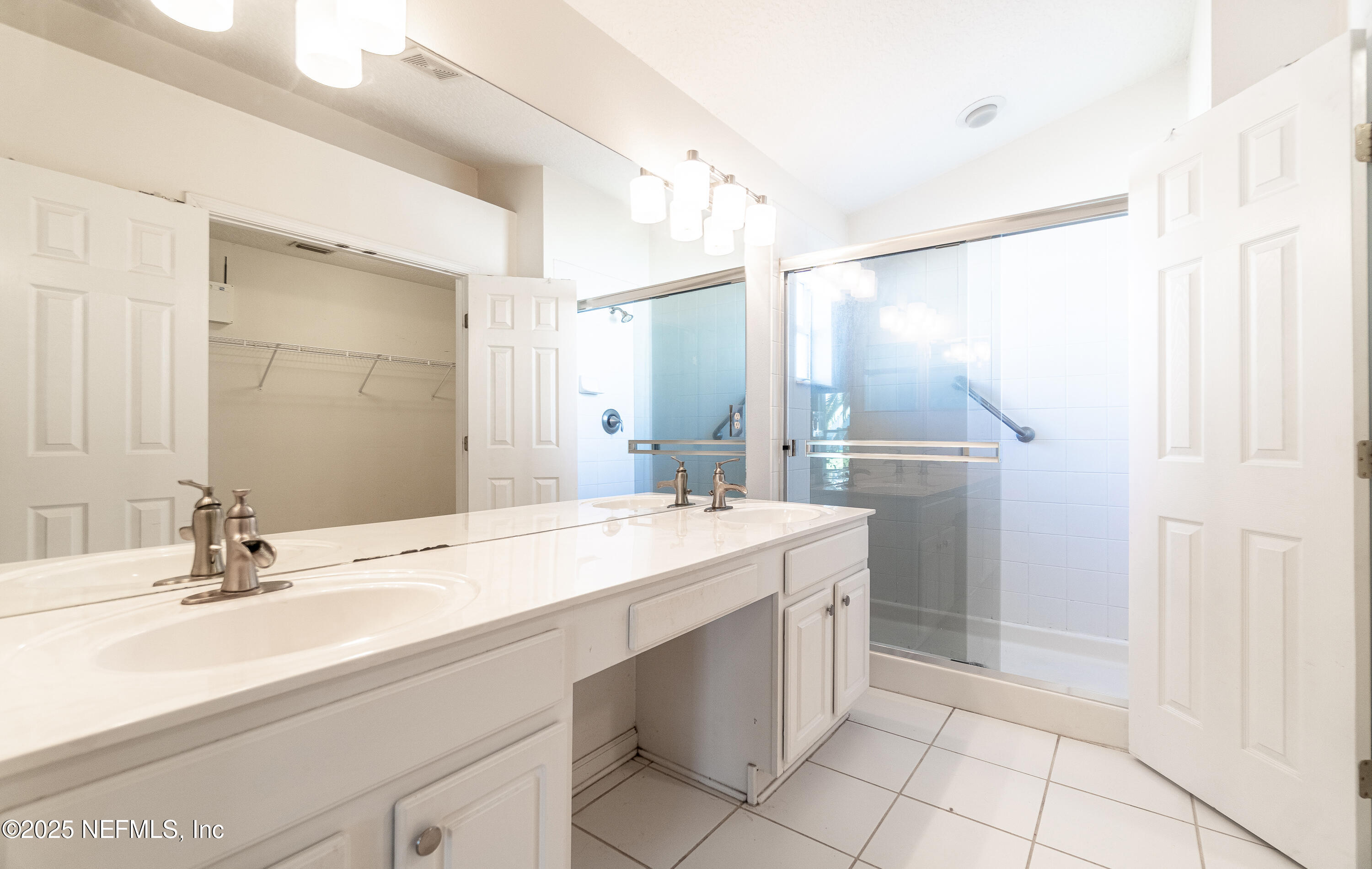 1325 Fairway Village Drive Fleming Island, FL 32003 - Photo 14 of 36 a bathroom with a double vanity sink mirror and shower