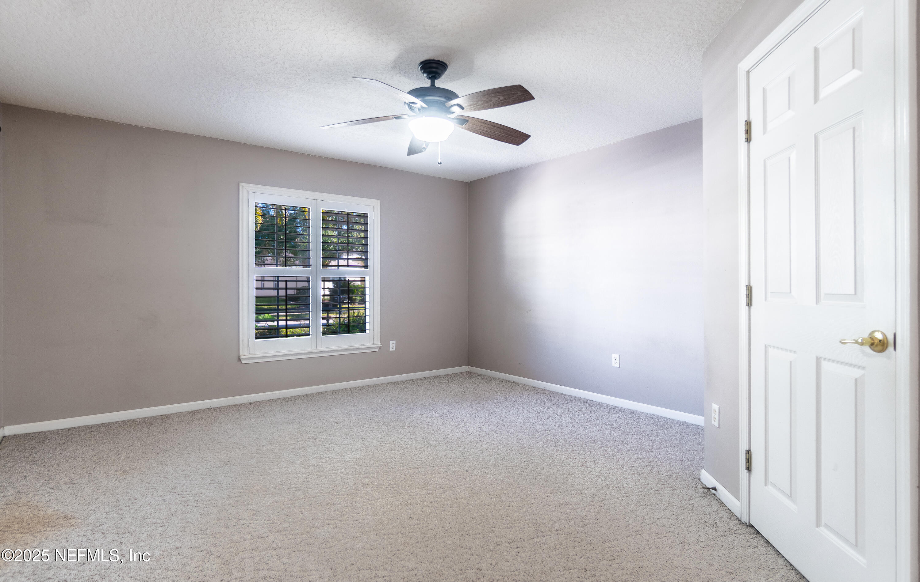 1325 Fairway Village Drive Fleming Island, FL 32003 - Photo 16 of 36 a view of an empty room with a window