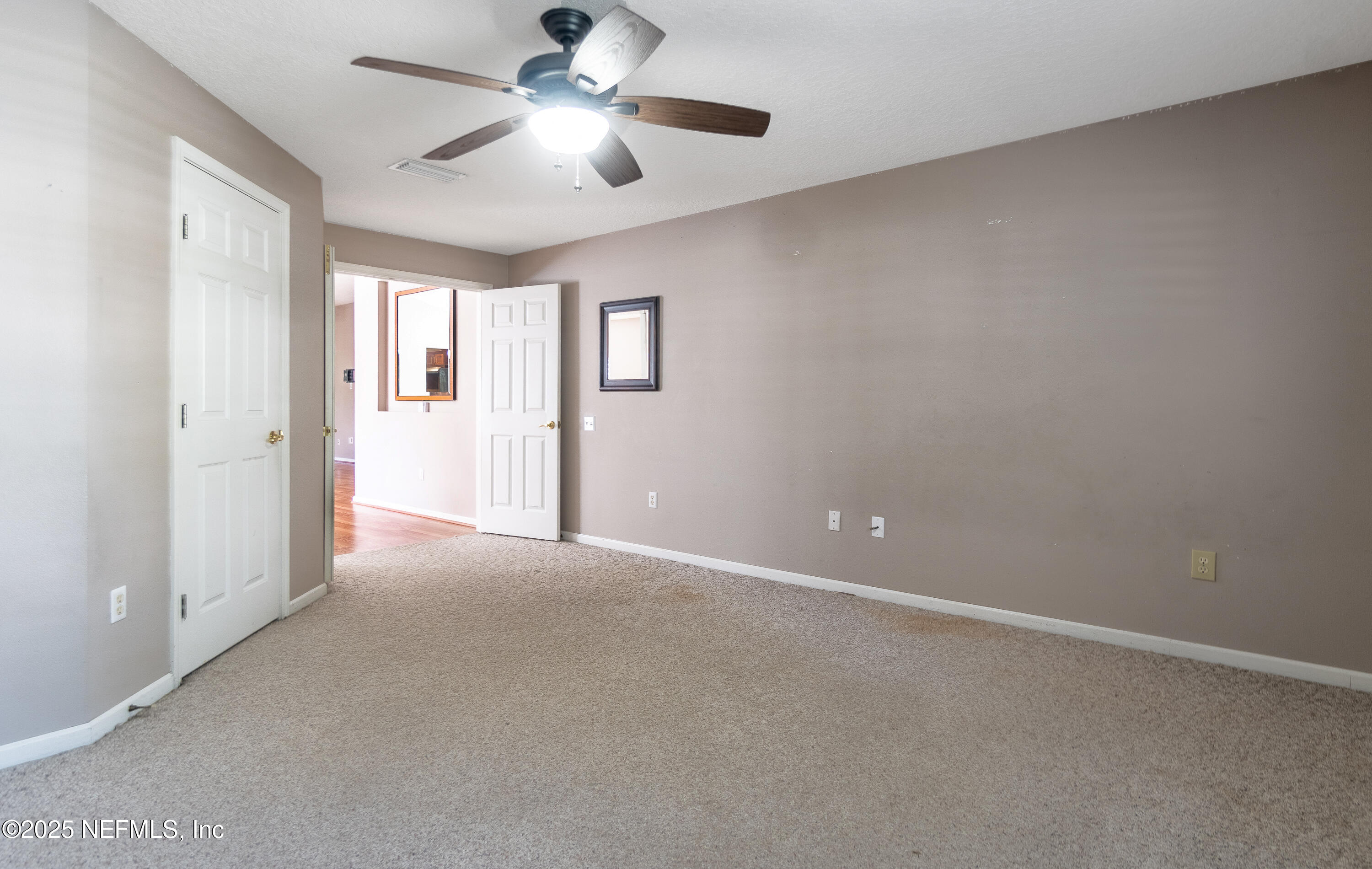 1325 Fairway Village Drive Fleming Island, FL 32003 - Photo 17 of 36 a view of a livingroom with a ceiling fan and window