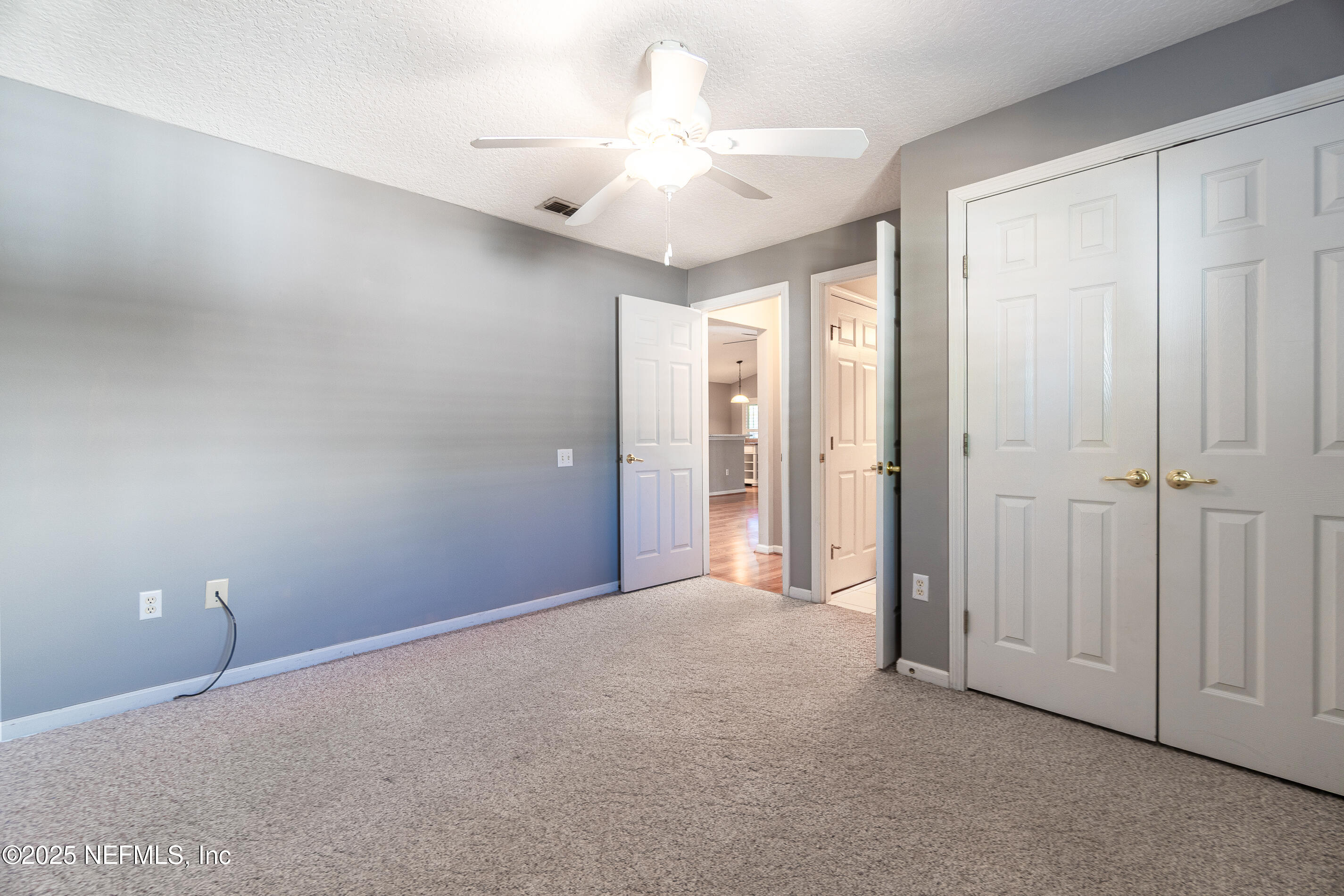 1325 Fairway Village Drive Fleming Island, FL 32003 - Photo 20 of 36 a view of a room with a ceiling fan and a window