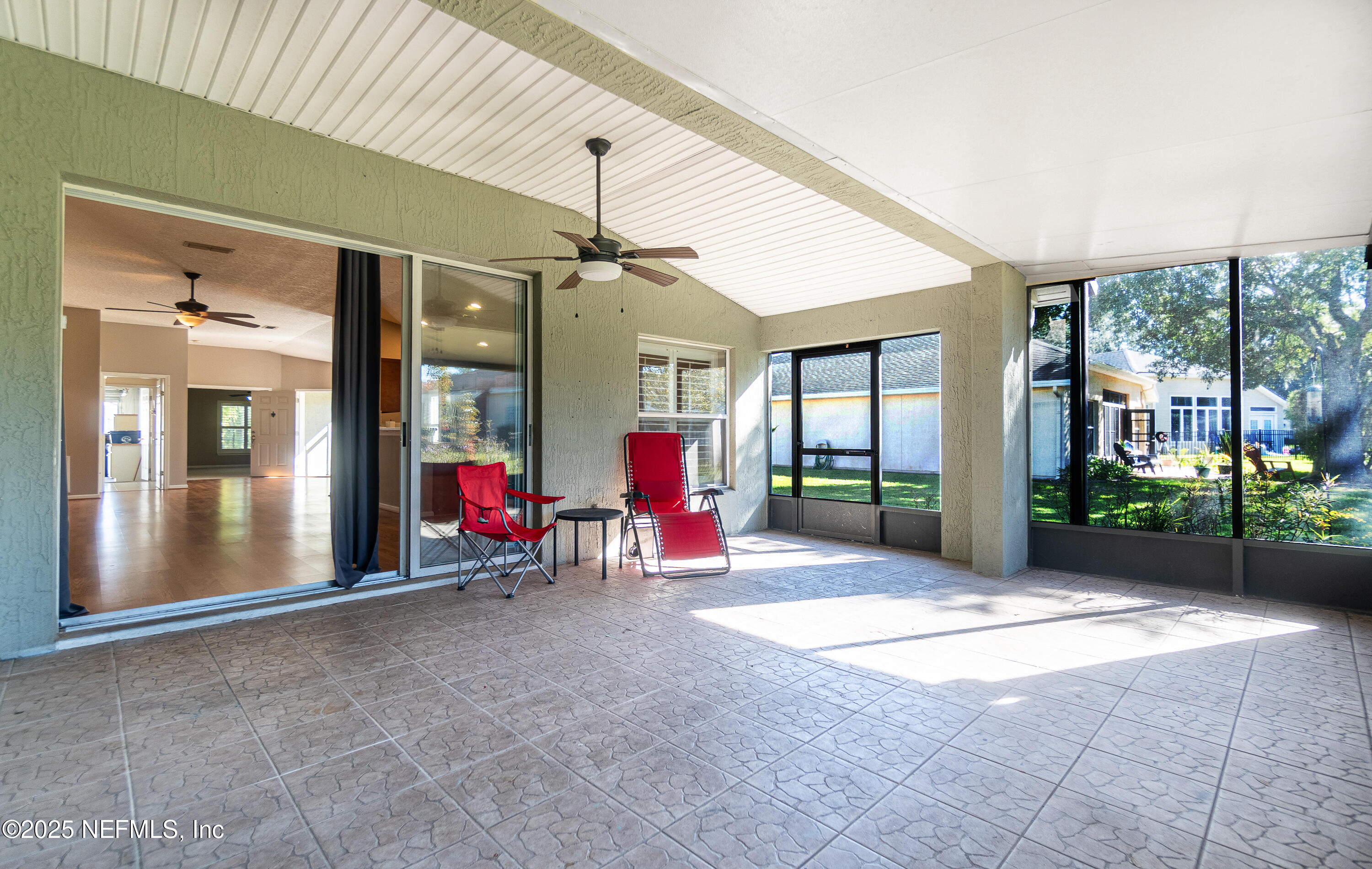 1325 Fairway Village Drive Fleming Island, FL 32003 - Photo 22 of 36 a view of a porch with furniture and front door