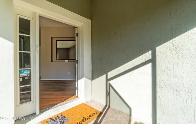 a view of a room with wooden floor and staircase