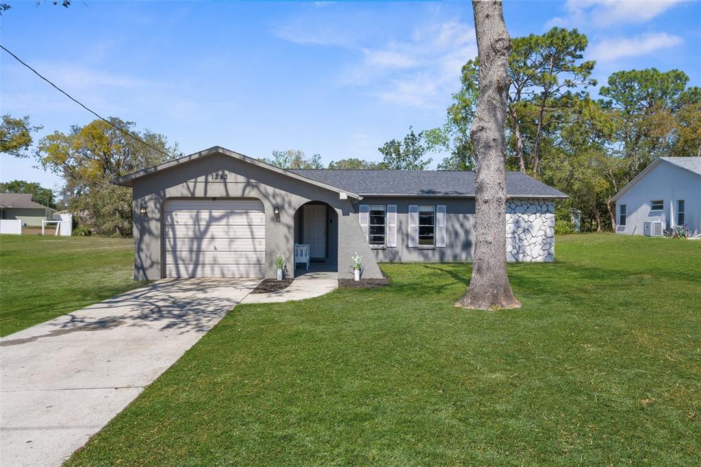 1283 Coble Road Spring Hill, FL 34608 - Photo 1 of 1 a front view of a house with a yard