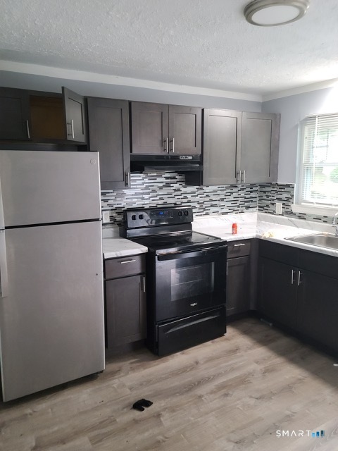 50 Angel Drive, Unit D Waterbury, CT 06708 - Photo 1 of 4 a kitchen with a stove and a refrigerator