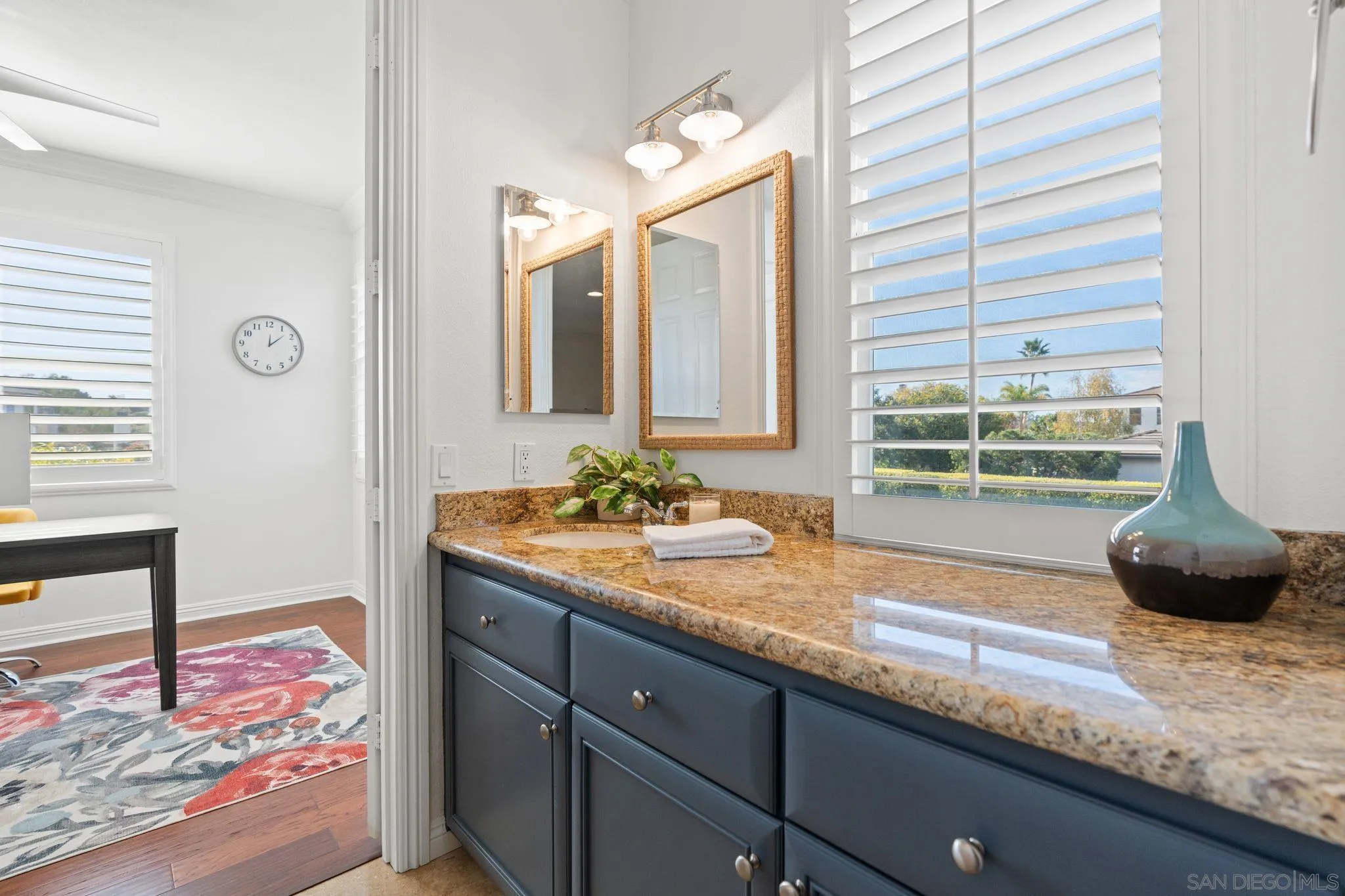 2887 Corte Morera Carlsbad, CA 92009 - Photo 32 of 68 a bathroom with a granite countertop sink and a large mirror