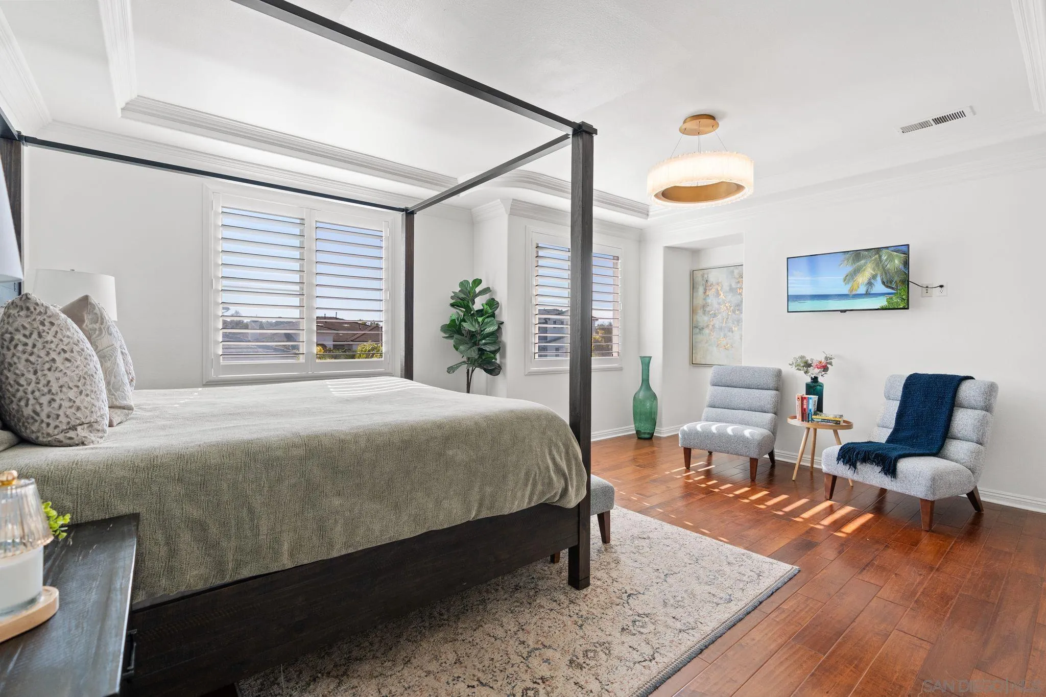 2887 Corte Morera Carlsbad, CA 92009 - Photo 35 of 68 a bedroom with a bed chair and wooden floor