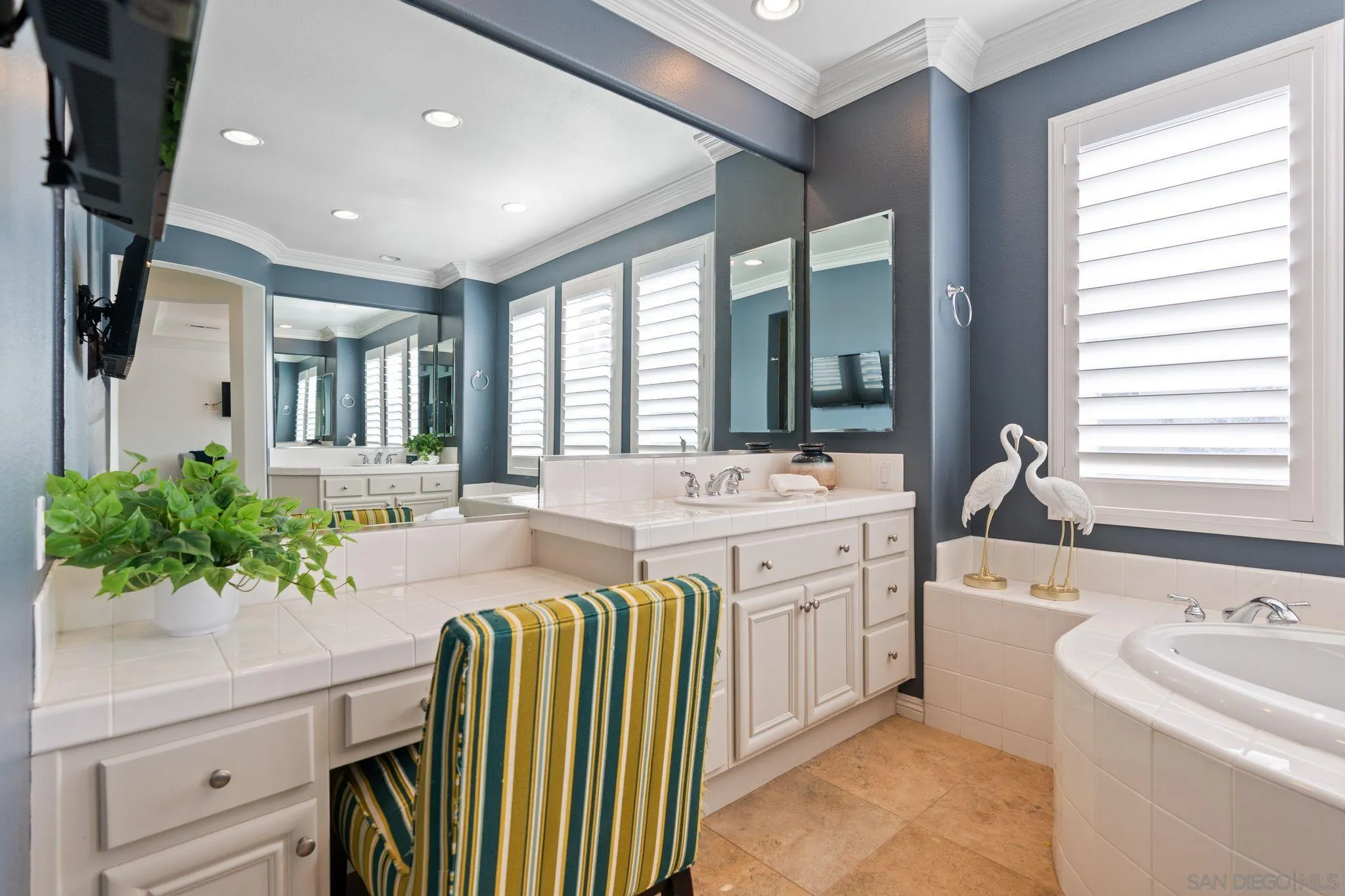 2887 Corte Morera Carlsbad, CA 92009 - Photo 38 of 68 a spacious bathroom with a sink a mirror a bathtub and next to a window