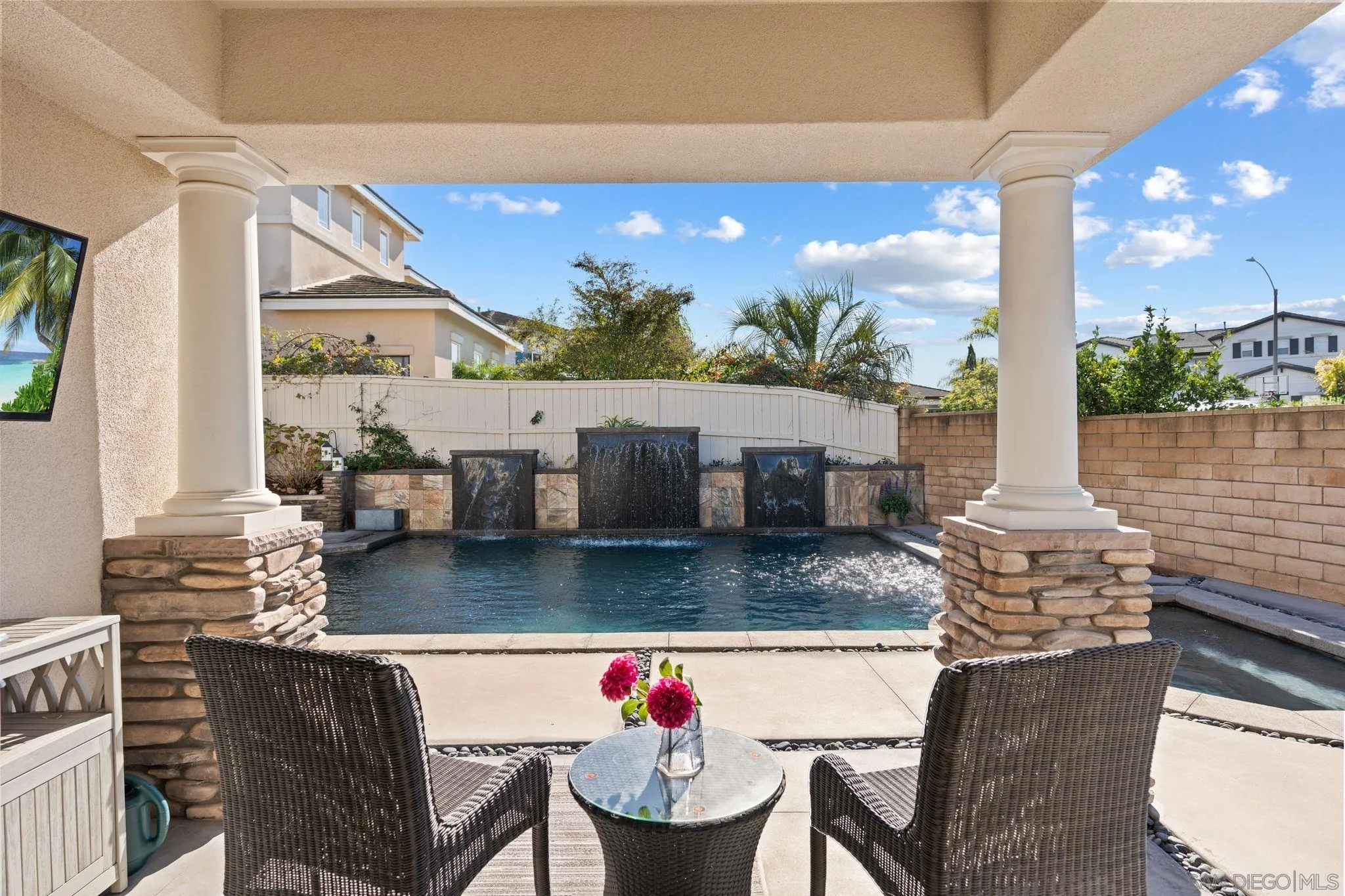 2887 Corte Morera Carlsbad, CA 92009 - Photo 53 of 68 a view of a dining table and chairs with the floor to ceiling window and potted plants
