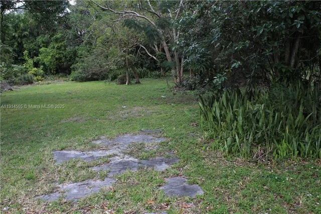 a backyard of a house and trees in the background