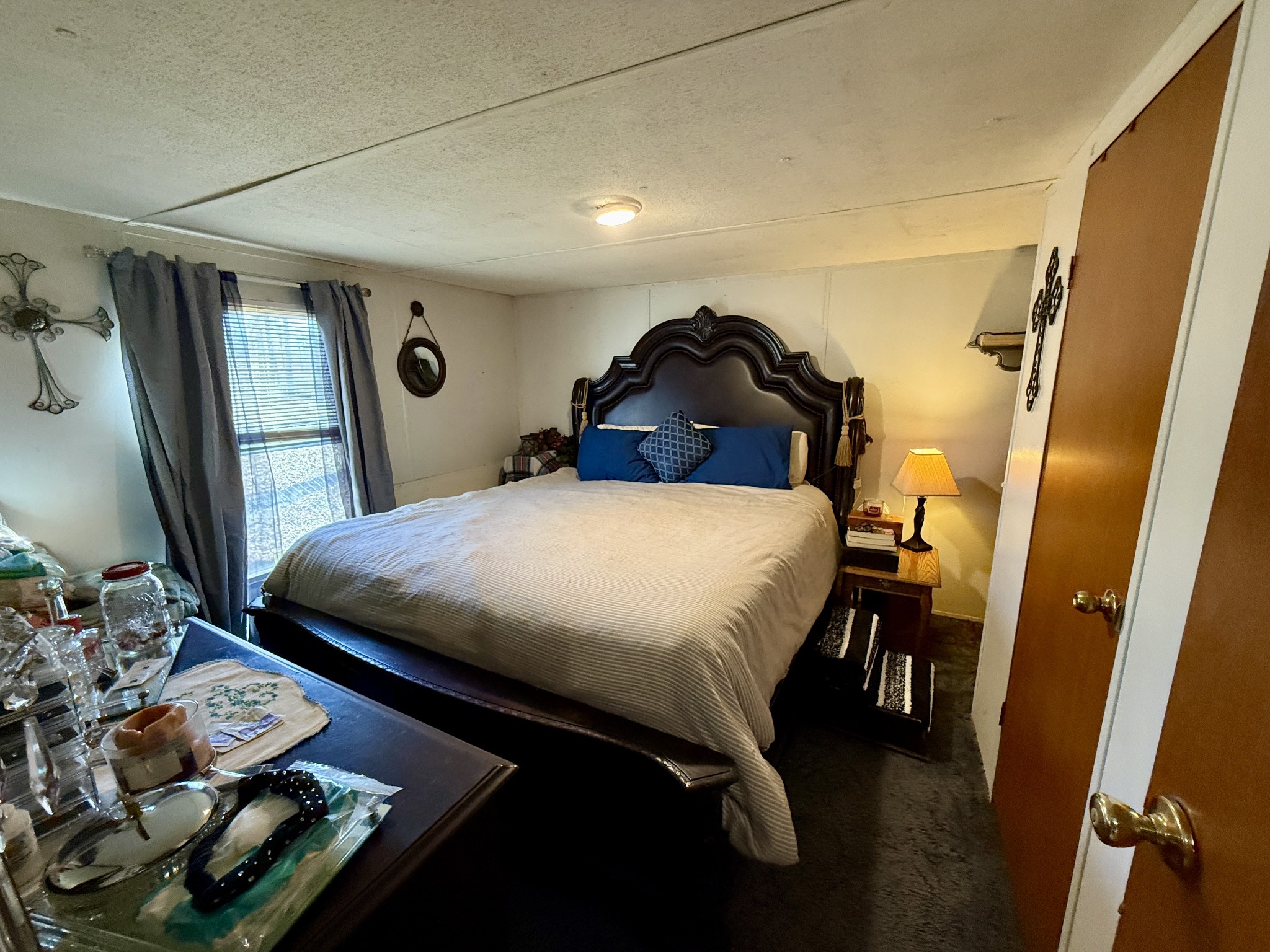 299 Sunset Drive Holladay, TN 38341 - Photo 17 of 27 a bedroom with a bed and a mirror on the wall