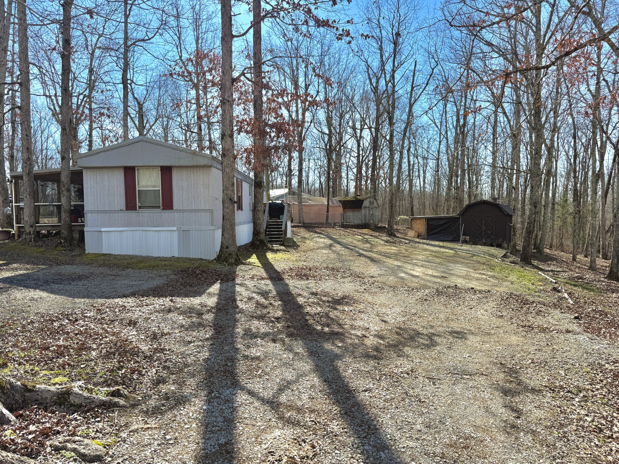 299 Sunset Drive Holladay, TN 38341 - Photo 22 of 27 a backyard of a house with lots of green space