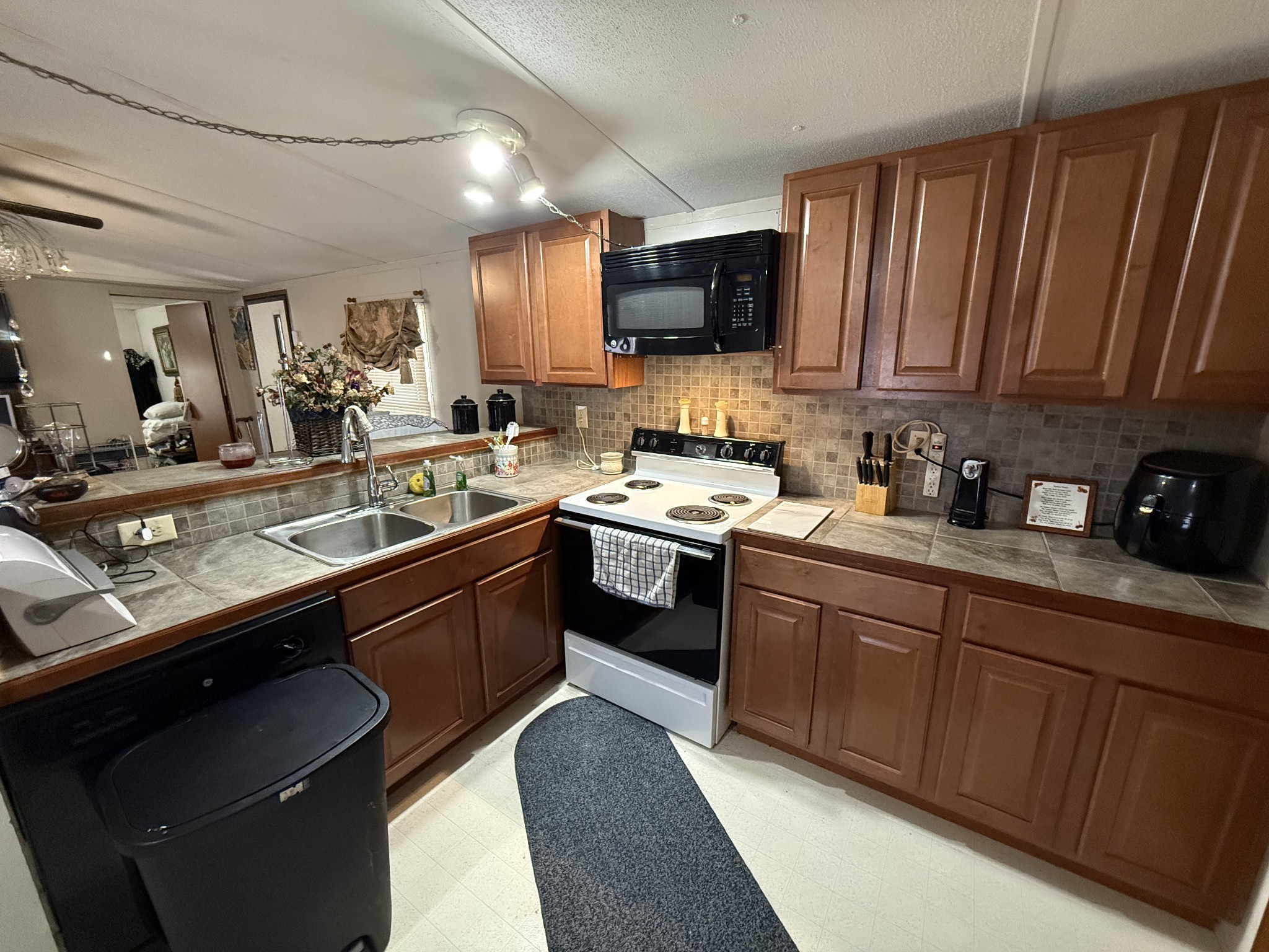 299 Sunset Drive Holladay, TN 38341 - Photo 5 of 27 a kitchen with a sink stove and microwave