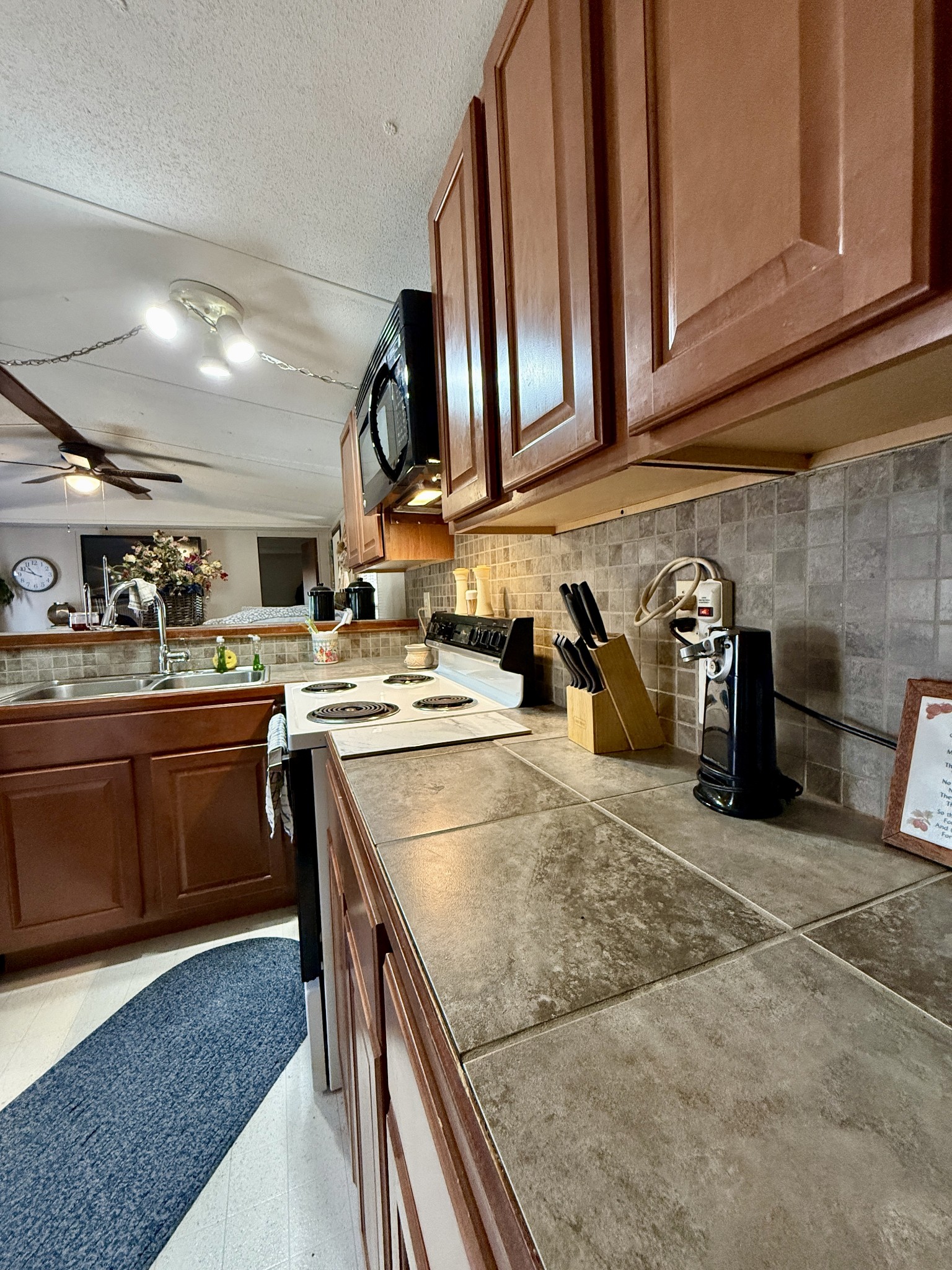 299 Sunset Drive Holladay, TN 38341 - Photo 6 of 27 a kitchen with stainless steel appliances granite countertop a sink stove and cabinets
