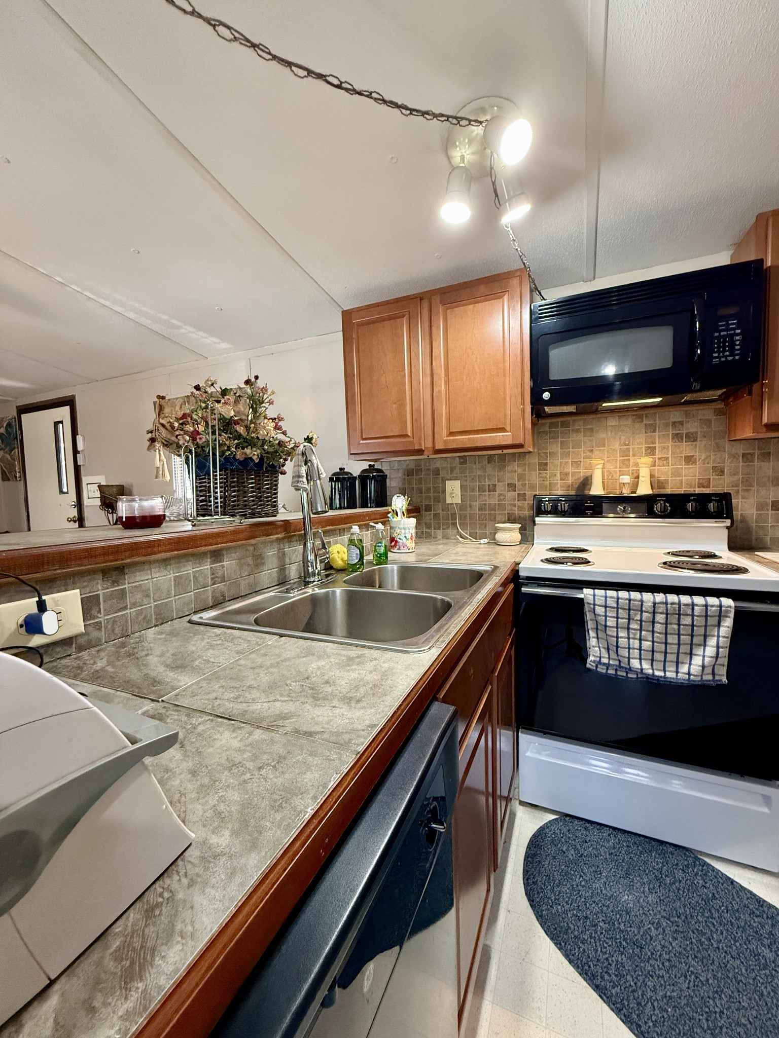 299 Sunset Drive Holladay, TN 38341 - Photo 7 of 27 a kitchen with stainless steel appliances granite countertop a stove a sink and a microwave