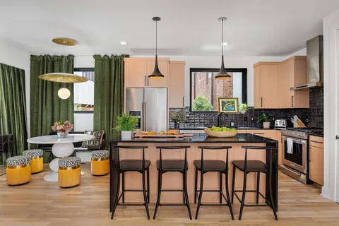 a dining table chairs and a kitchen view