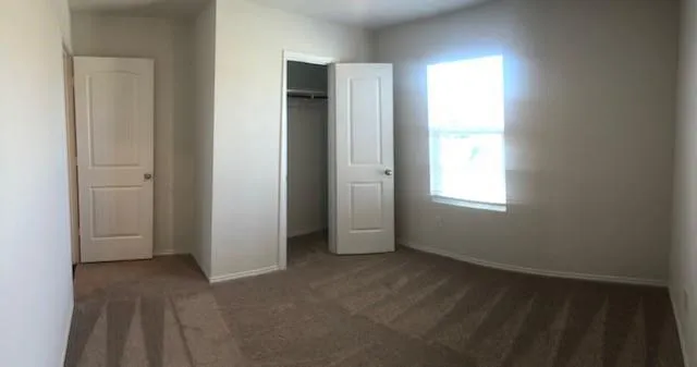 a view of kitchen with microwave and cabinets