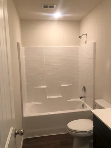 a kitchen with a sink cabinets and wooden floor