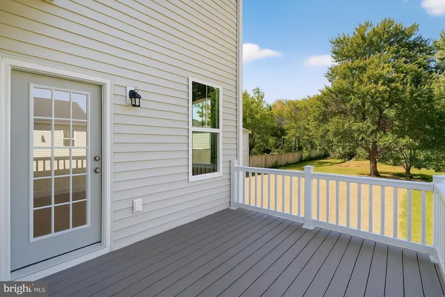 a view of deck with large trees and wooden floor