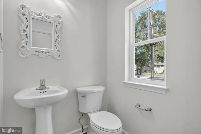 a white toilet sitting next to a bathroom sink