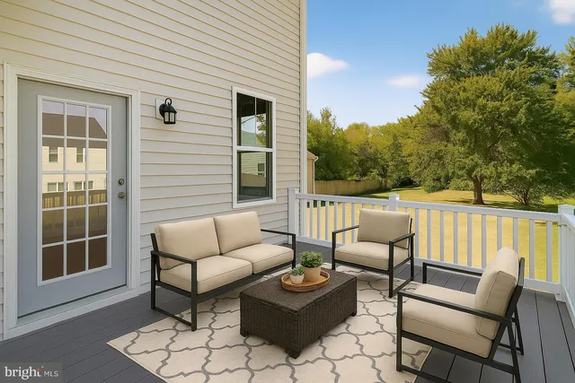a balcony with furniture and a potted plant