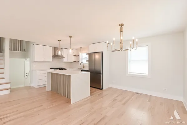 a kitchen with a refrigerator sink and cabinets