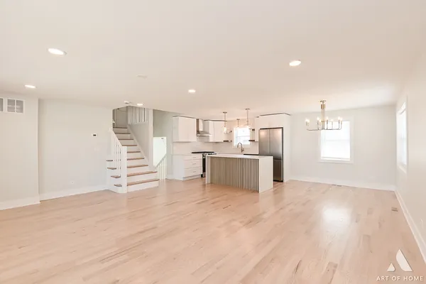 a view of kitchen with wooden floor and electronic appliances