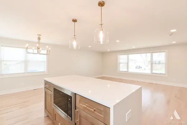a kitchen with a stove a sink and a window