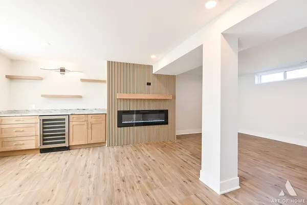 a view of a room with wooden floor and kitchen