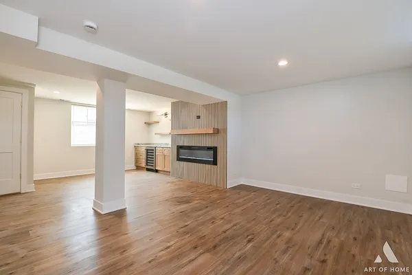 a view of a kitchen with a sink and a fireplace
