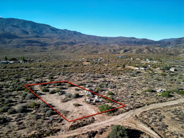 an aerial view of residential house and sandy dunes
