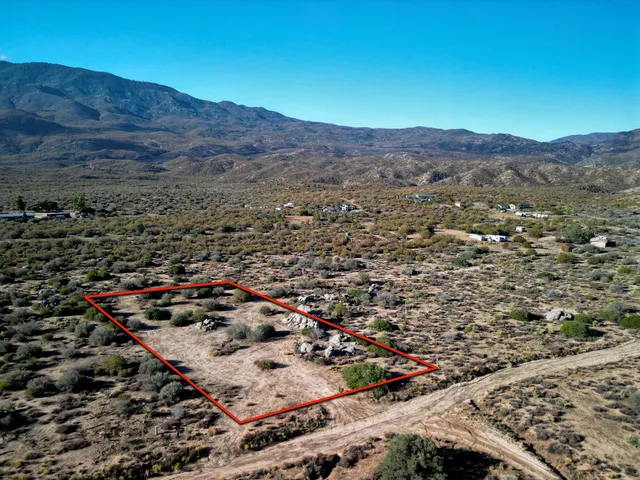 an aerial view of residential house and sandy dunes