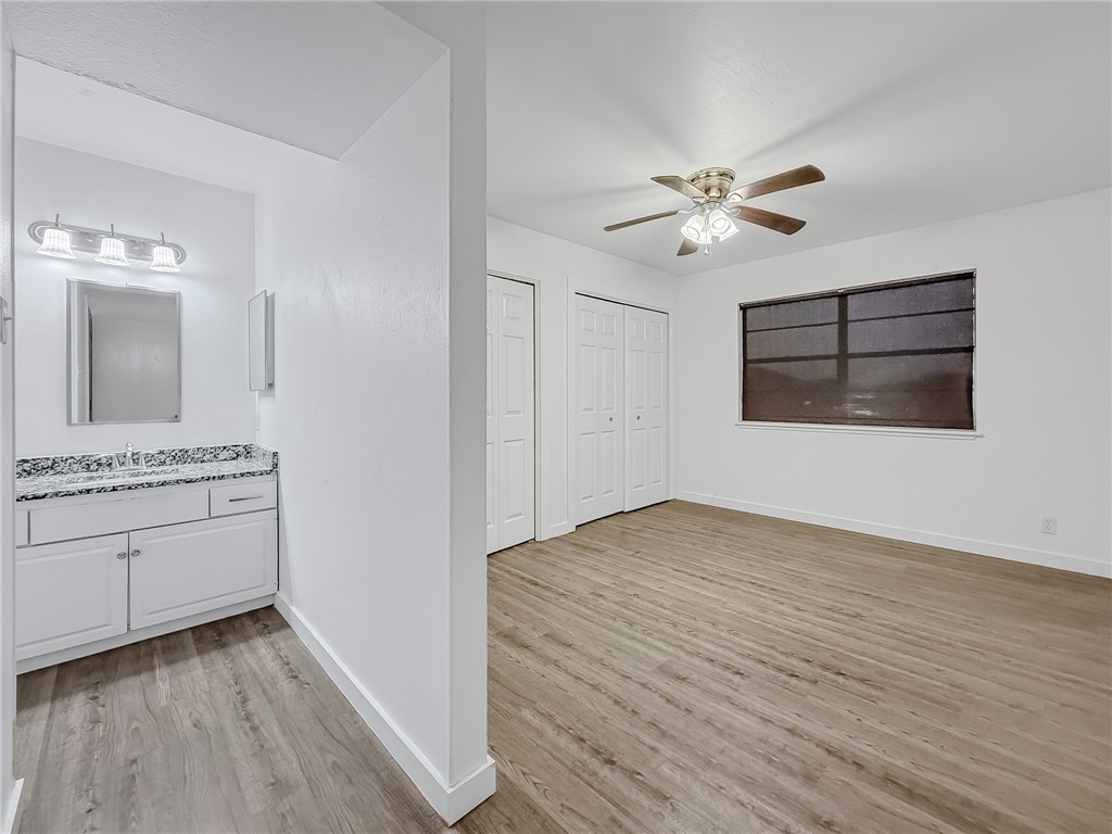 302 Easy Street, Unit B Corpus Christi, TX 78418 - Photo 11 of 27 a view of a hallway with a kitchen and a stove top oven
