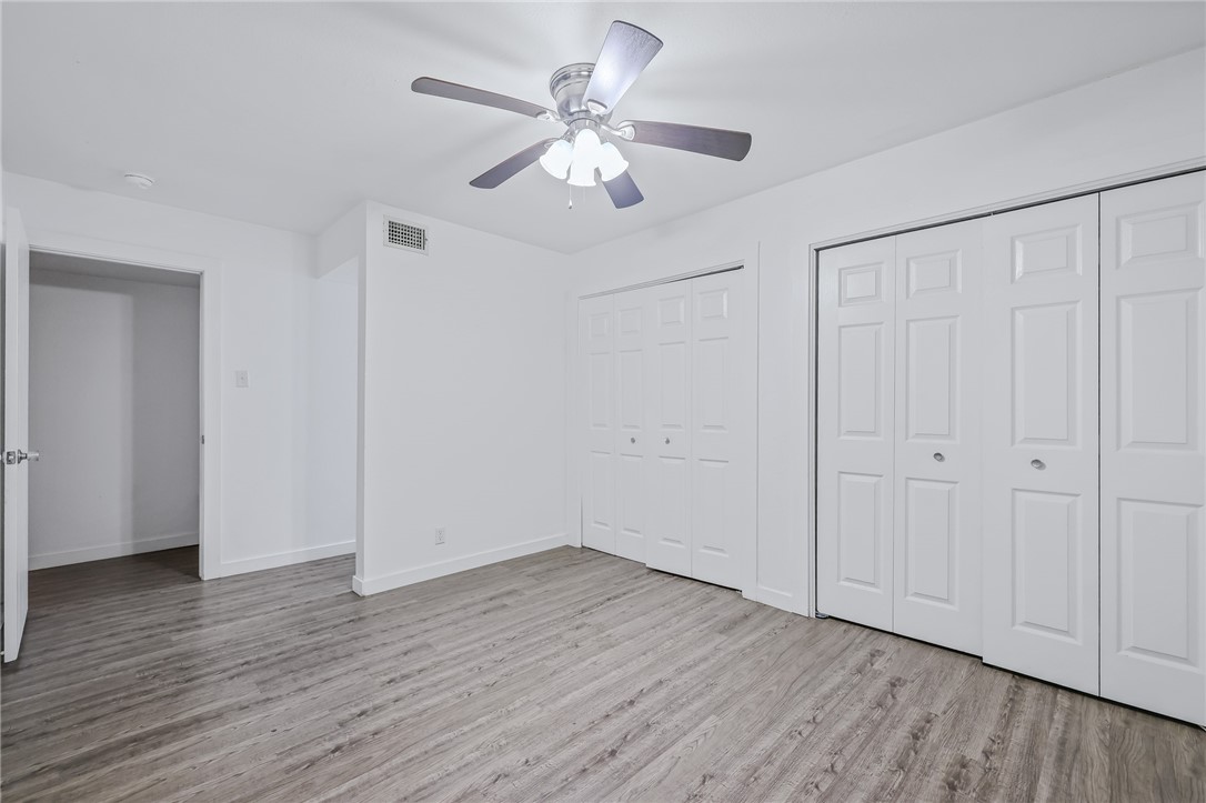 302 Easy Street, Unit B Corpus Christi, TX 78418 - Photo 12 of 27 a view of an empty room with wooden floor