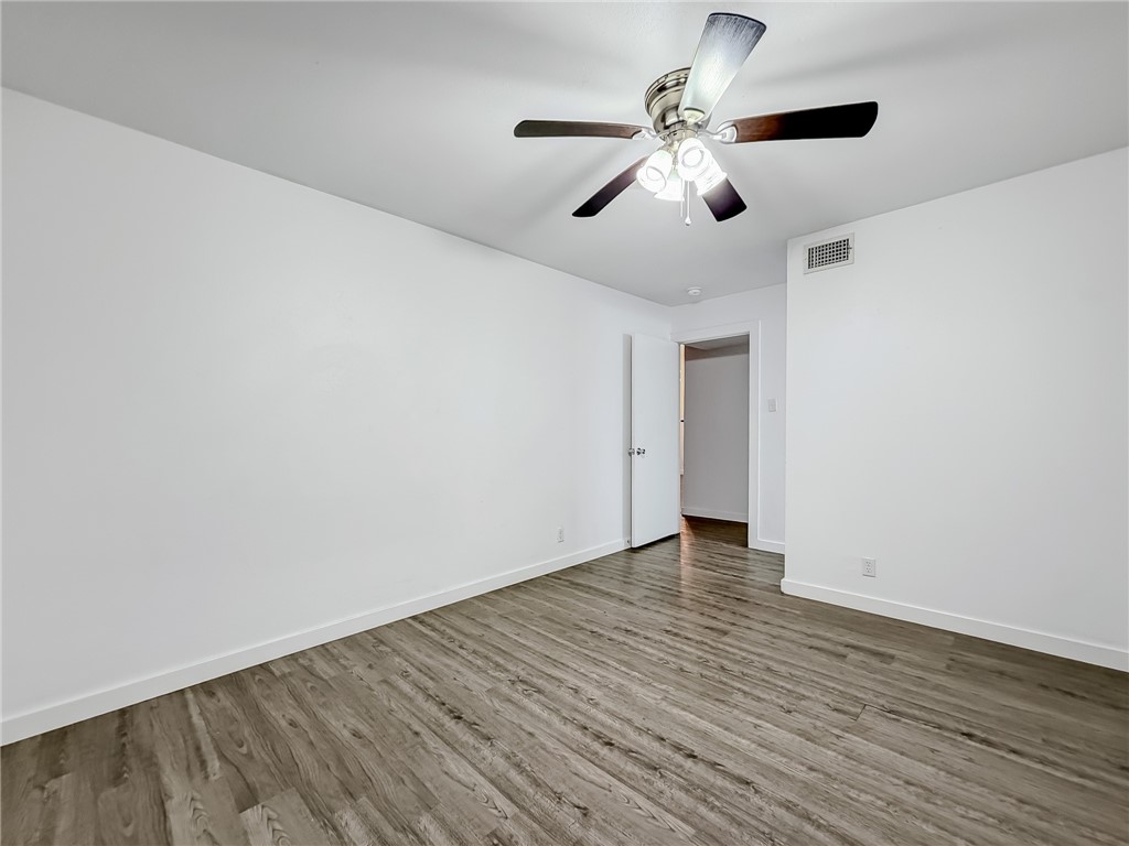 302 Easy Street, Unit B Corpus Christi, TX 78418 - Photo 13 of 27 a view of an empty room with wooden floor