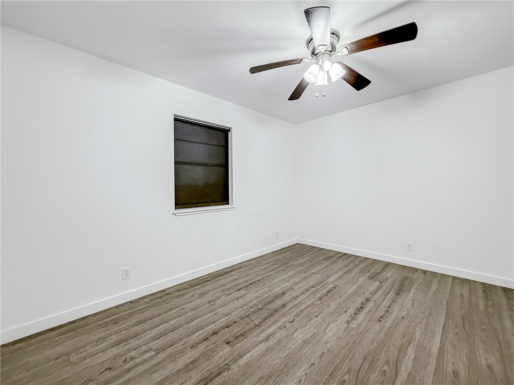 302 Easy Street, Unit B Corpus Christi, TX 78418 - Photo 15 of 27 wooden floor in an empty room with a window