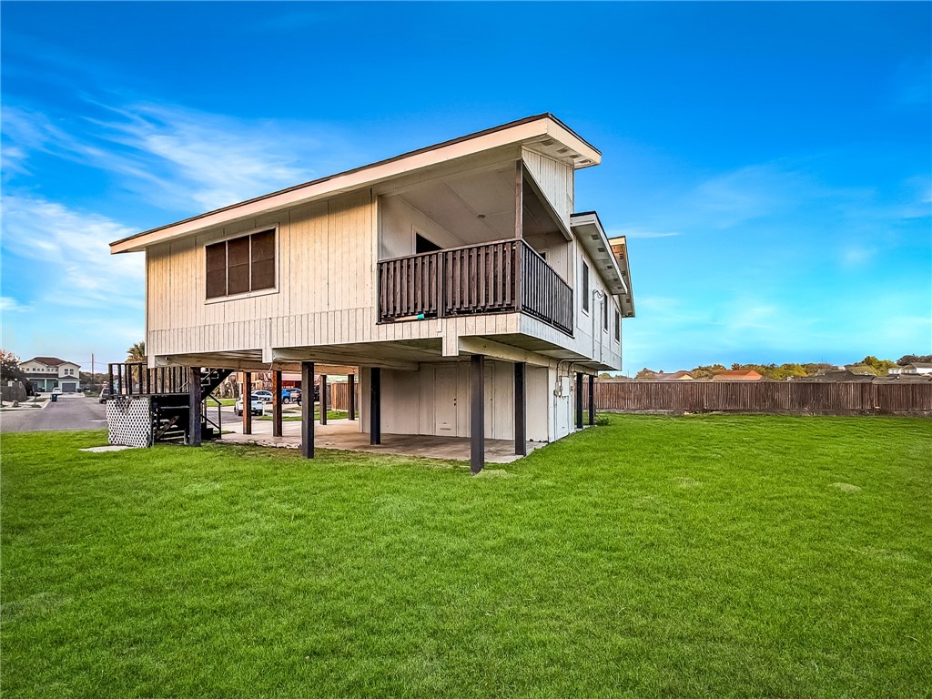 302 Easy Street, Unit B Corpus Christi, TX 78418 - Photo 23 of 27 a view of a house with a yard and deck