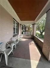 a living room with couches and a large window with outer view