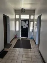 a view of a refrigerator in kitchen and a window