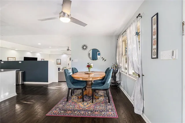 a dining room with furniture and wooden floor