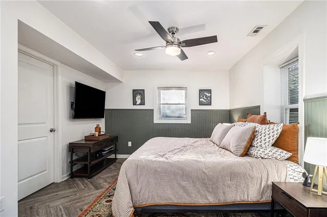 a bedroom with a bed and a flat screen tv