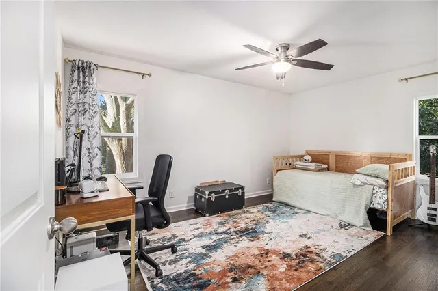 a living room with a bed furniture and a window