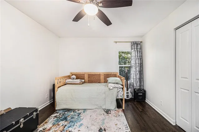 a bedroom with a bed and wooden floor