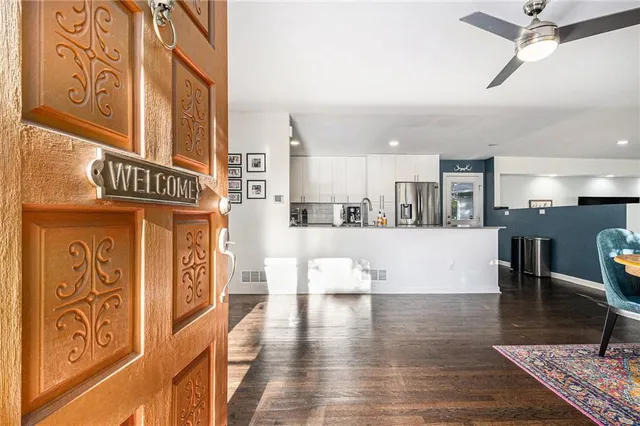 a view of a living room and kitchen with furniture