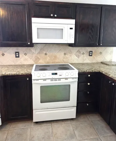 a kitchen with a stove and a cabinets