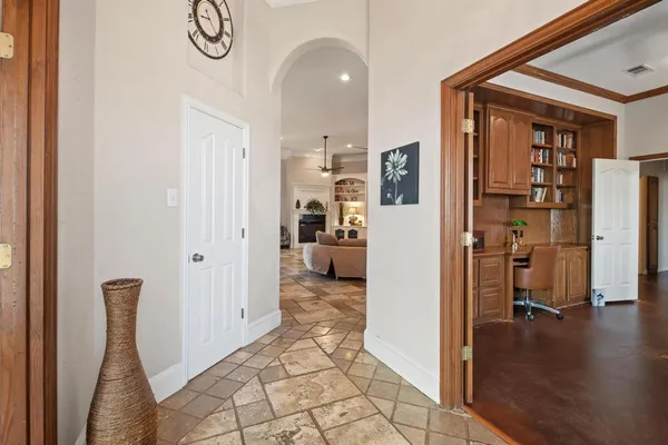 a view of a hallway with wooden floor and a living room