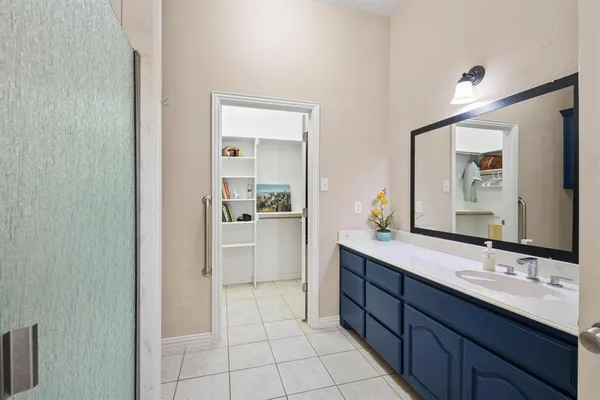 a bathroom with a double vanity sink a mirror and a