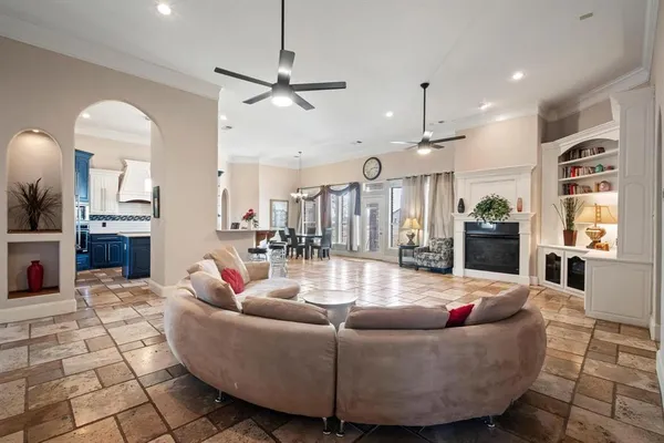 a living room with fireplace furniture and a chandelier