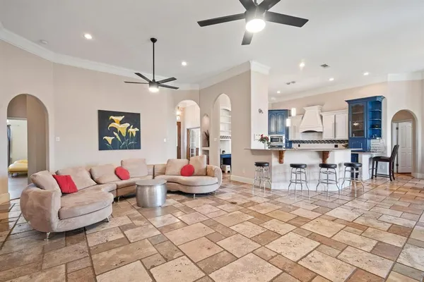 a living room with furniture and a chandelier