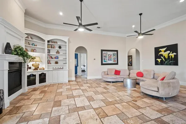 a living room with stainless steel appliances kitchen island furniture and a chandelier